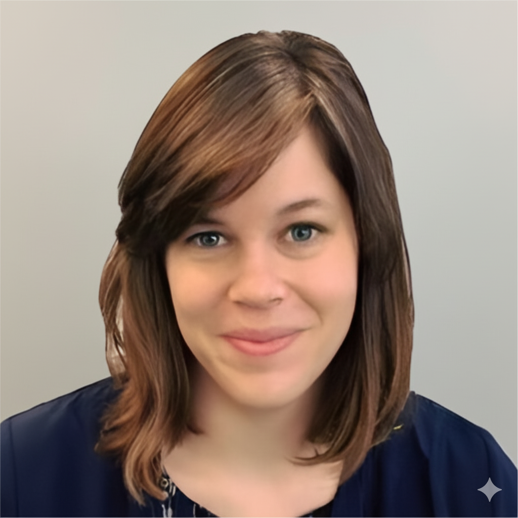 Portrait of a man with brown hair and glasses on a flat gray background.